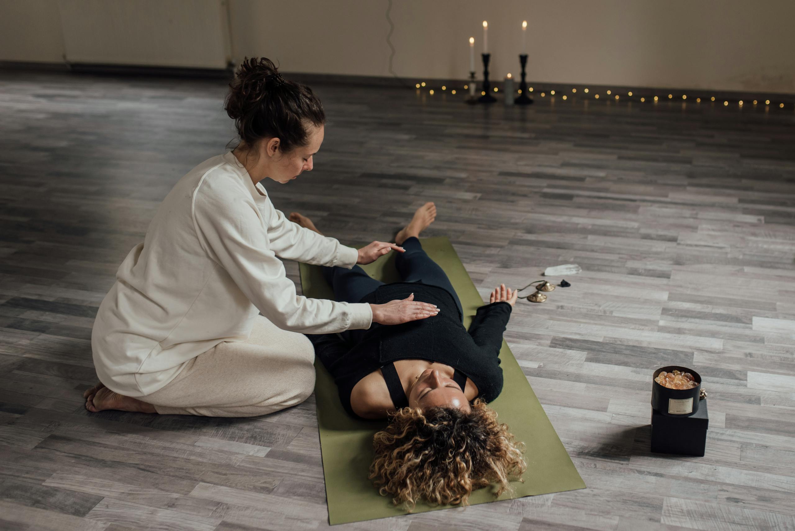 Therapist Holding a Woman Lying on the Floor