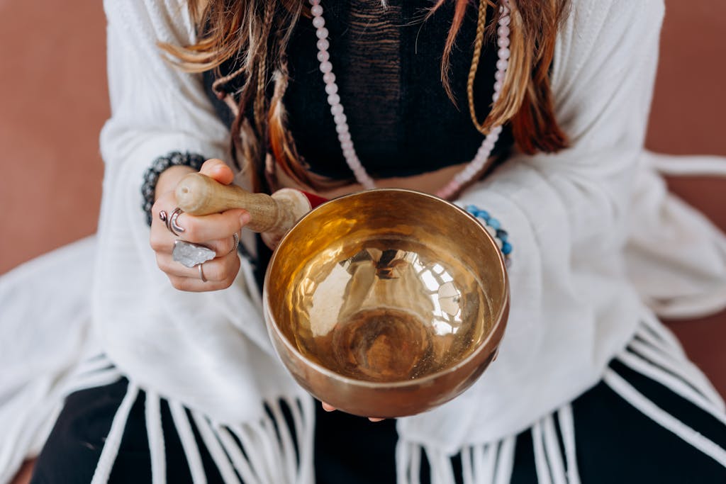 Woman in White Long Sleeve Shirt Holding Gold Round Bowl